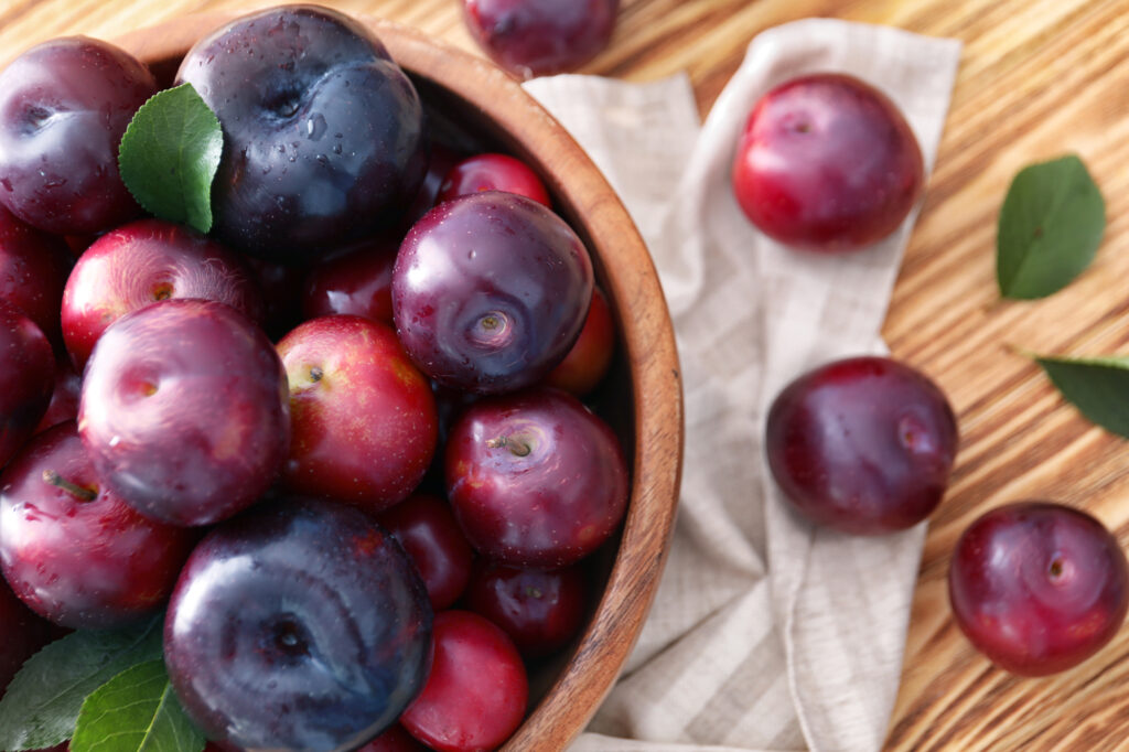 A Picture of plums on a wooden table